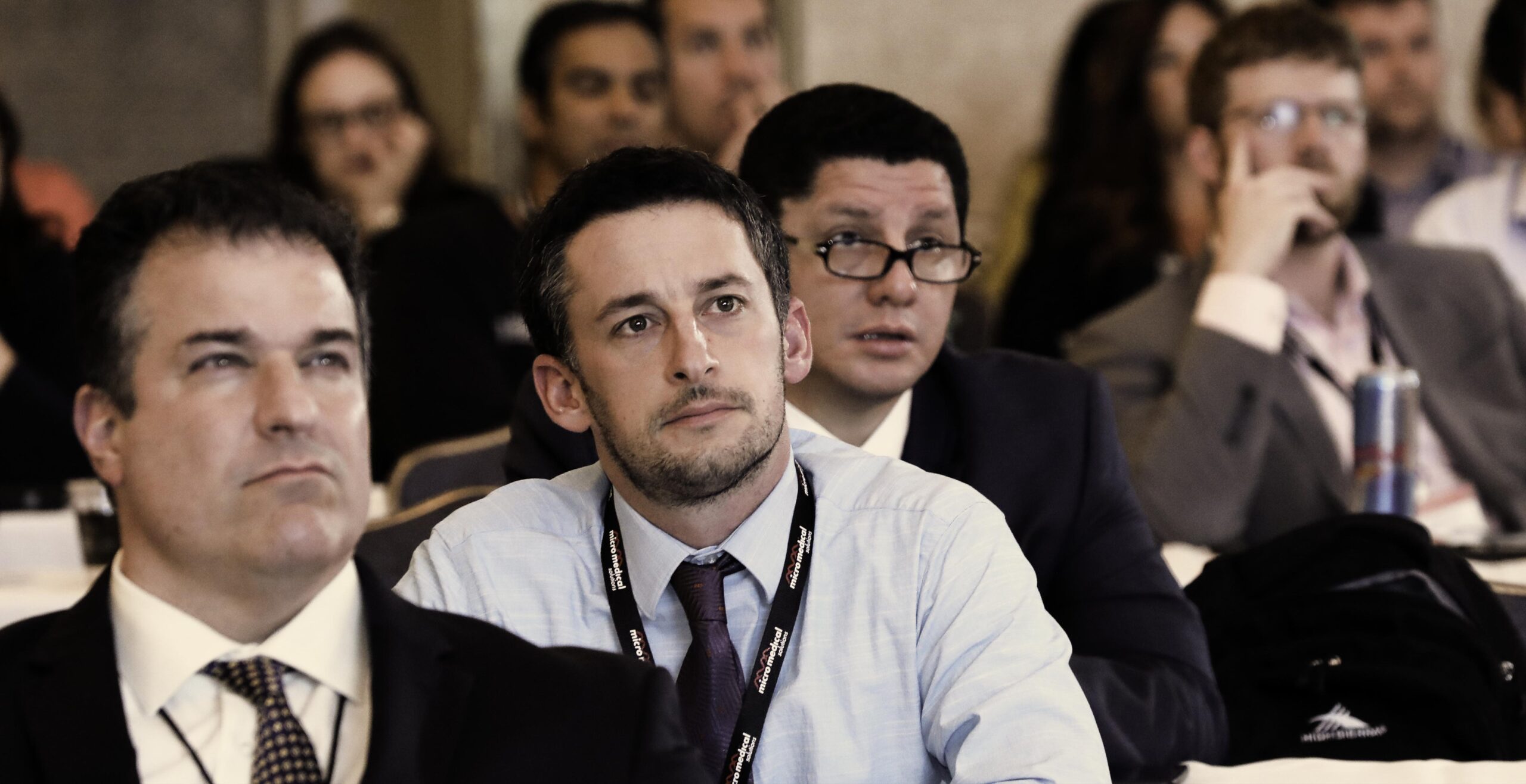 Covention Photography of males looking intently at the speaker during a conference.