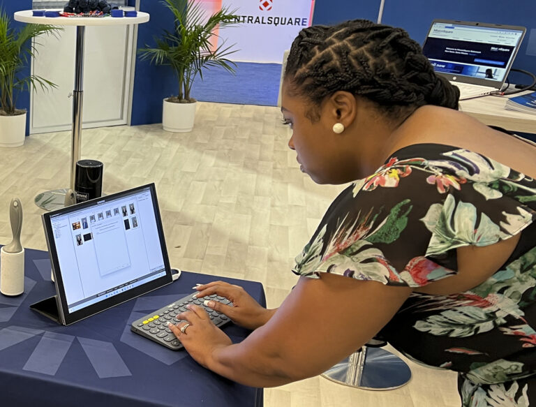 Attendee typing her email at a headshot station laptop to receive her photos in real time