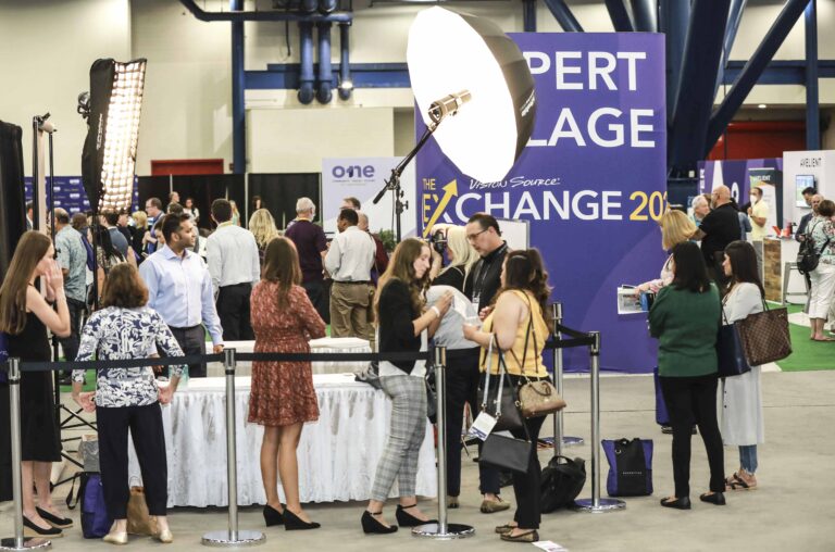 Headshot lounge at a trade show, attendees lining up for conference headshots on the exhibitor floor