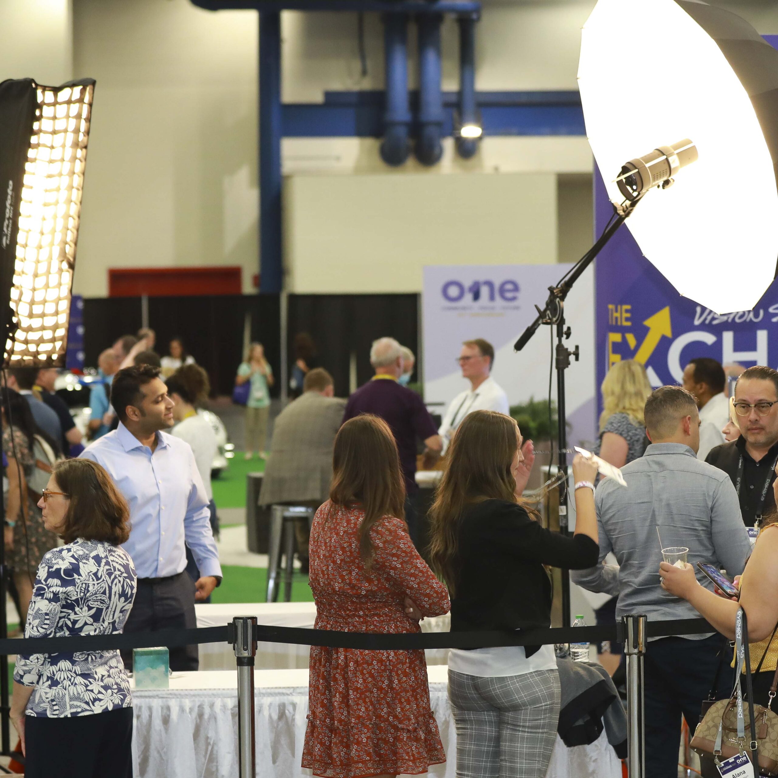 Attendees queued at a branded trade show headshot lounge, photographed for the sponsor's post event report