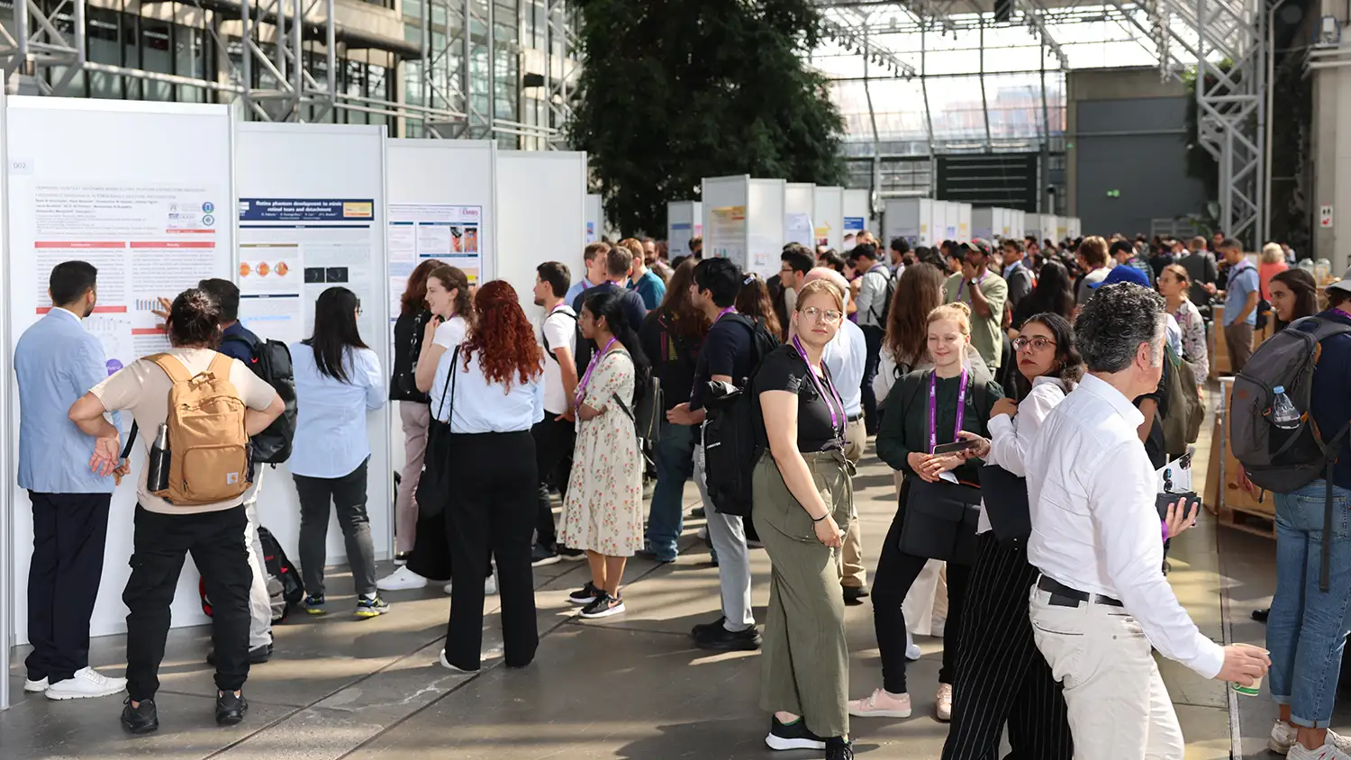 Attendees reviewing research posters during a poster session at a medical conference