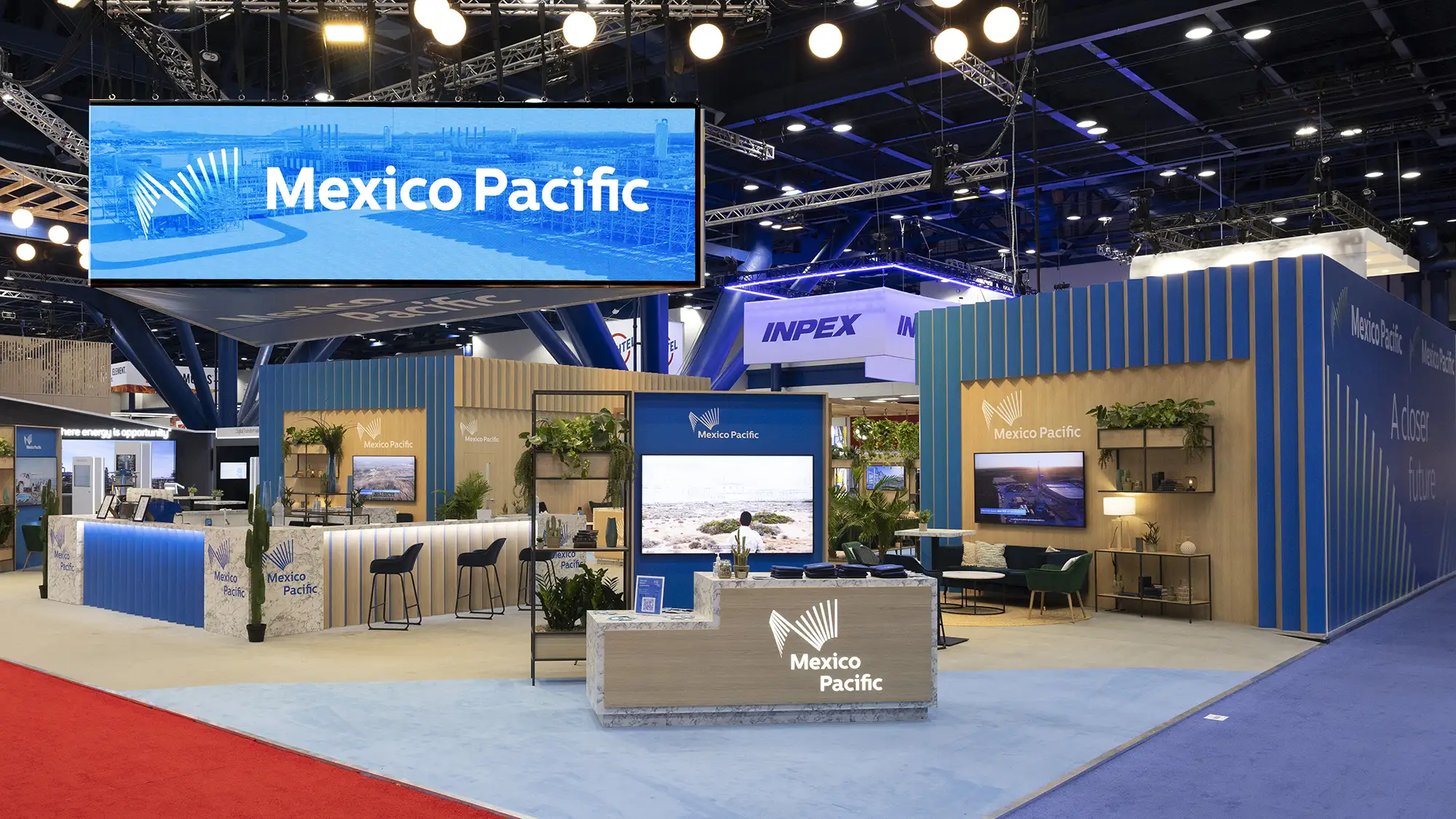 Wide angle view of a trade show floor with sponsor pavilions and attendee traffic, used in sponsorship recap decks