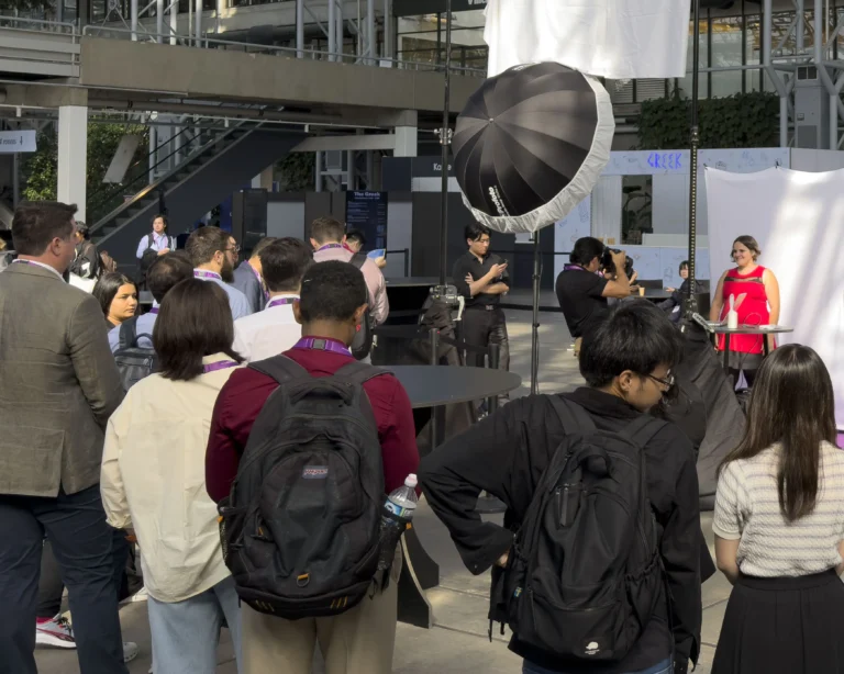 Attendees lined up at a headshot station during an EMBC conference in Copenhagen, Denmark