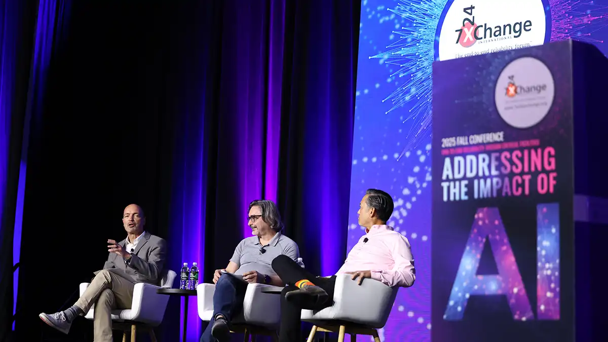 Panel discussion at the 7x24 Exchange 2025 Fall Conference with sponsor branding on the main stage screen