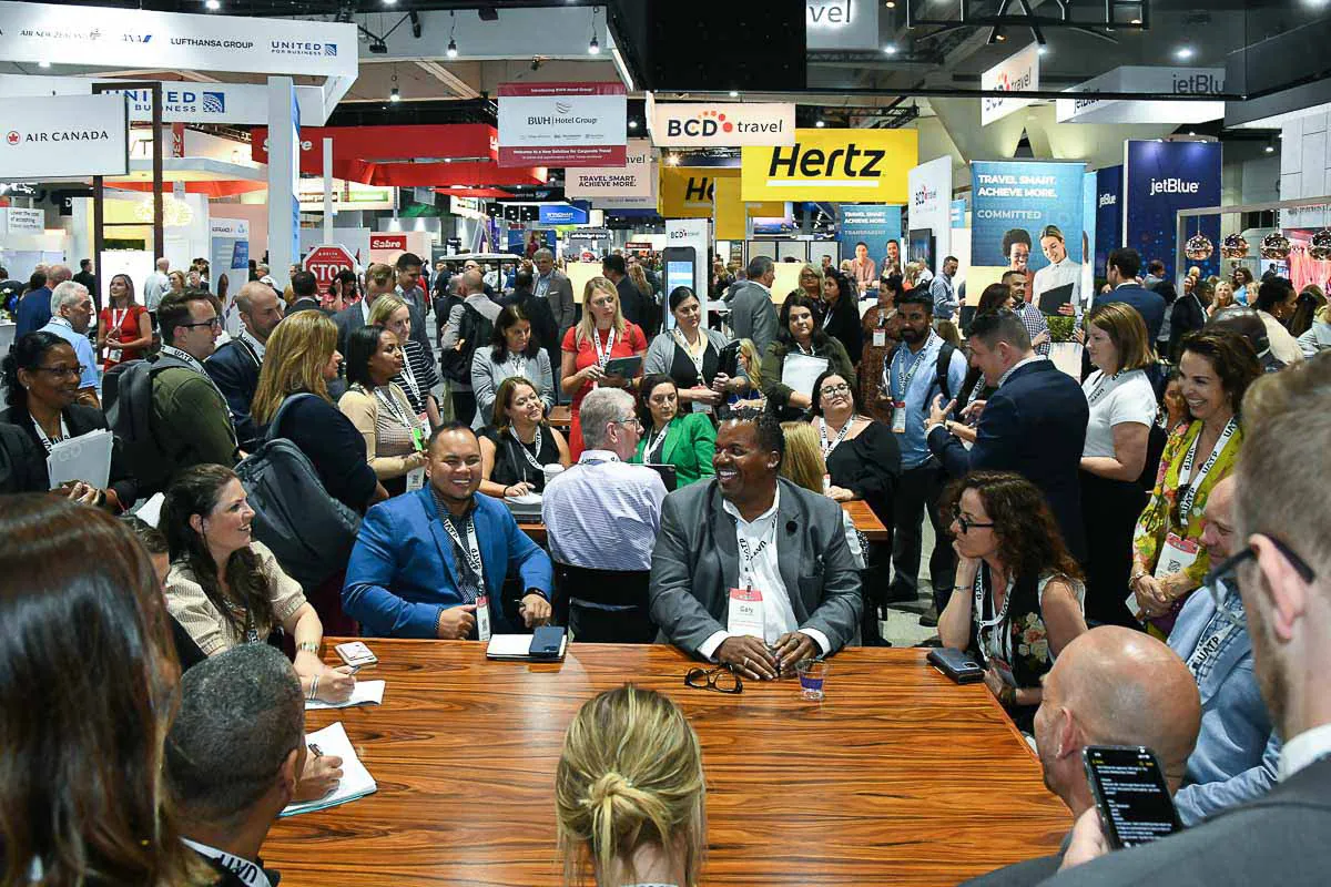 San Diego expo conference photography capturing a candid meeting from above on a busy tradeshow floor near a BCD booth