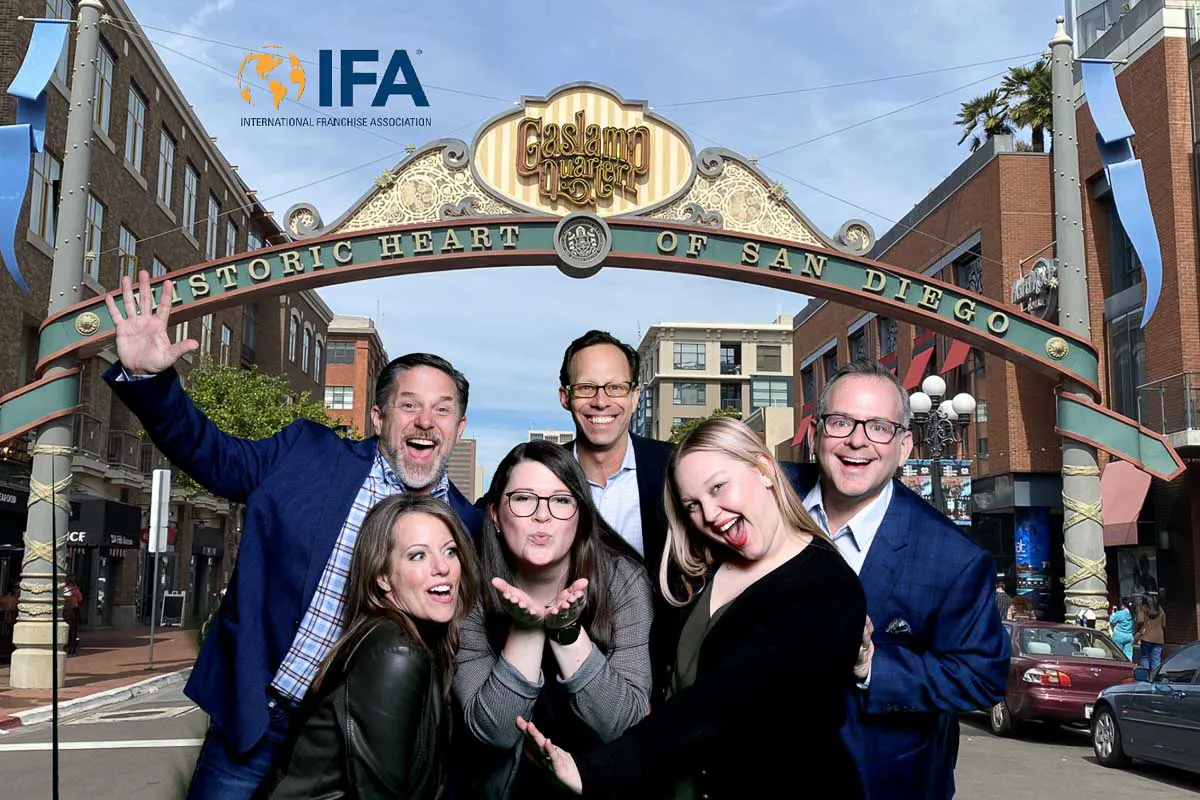 San Diego corporate activation photography capturing a fun group portrait over a custom branded Gaslamp Quarter backdrop.
