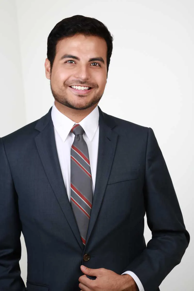 Finished corporate headshot of a businessman in a navy suit delivered onsite at a headshot lounge activation, the same standard we deliver at events nationwide