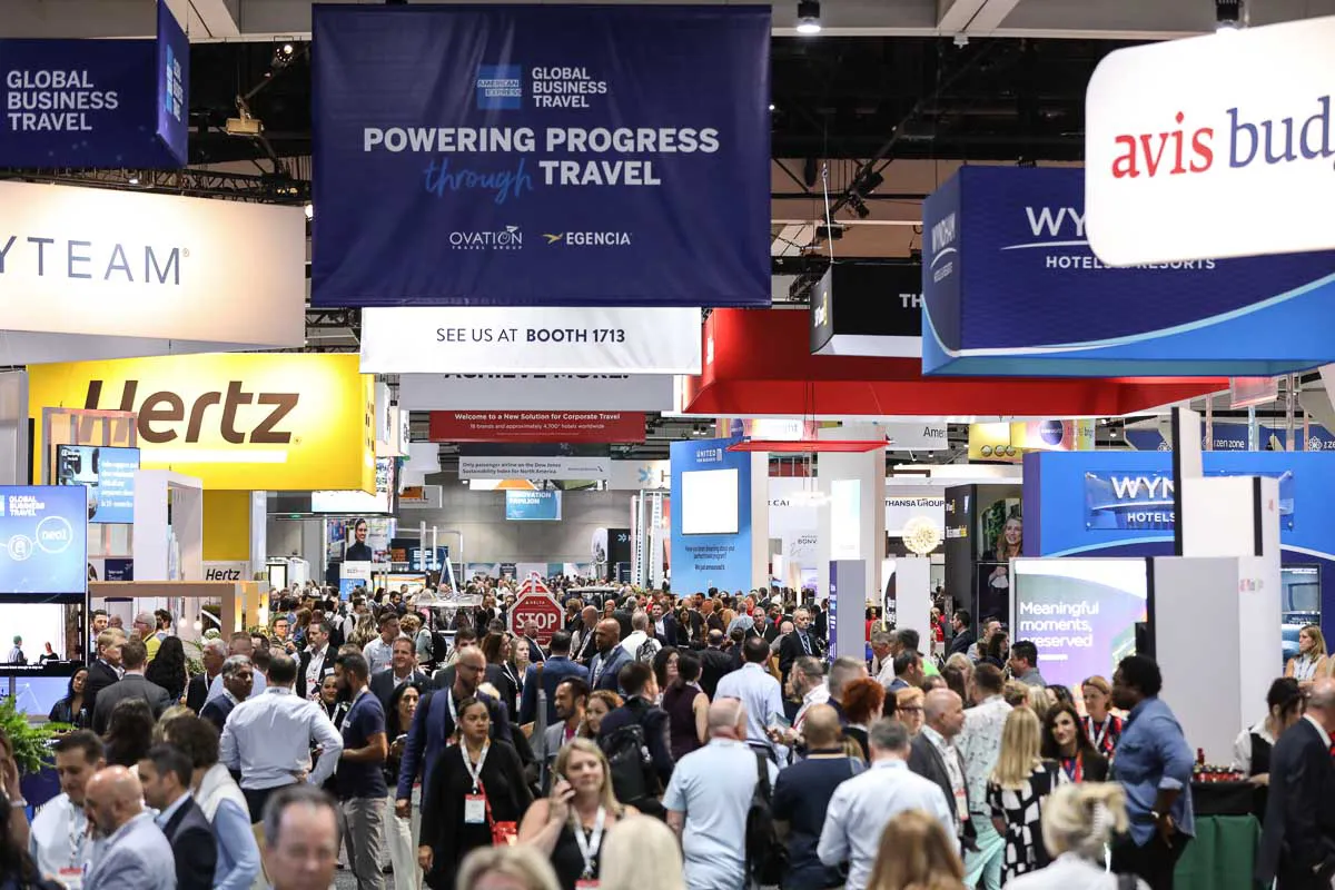 San Diego corporate tradeshow photography showcasing a busy expo hall floor with Hertz and Wyndham banners hanging above