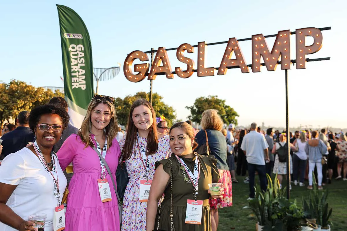 Gaslamp Quarter convention photography featuring four attendees posing under the illuminated Gaslamp sign in San Diego.