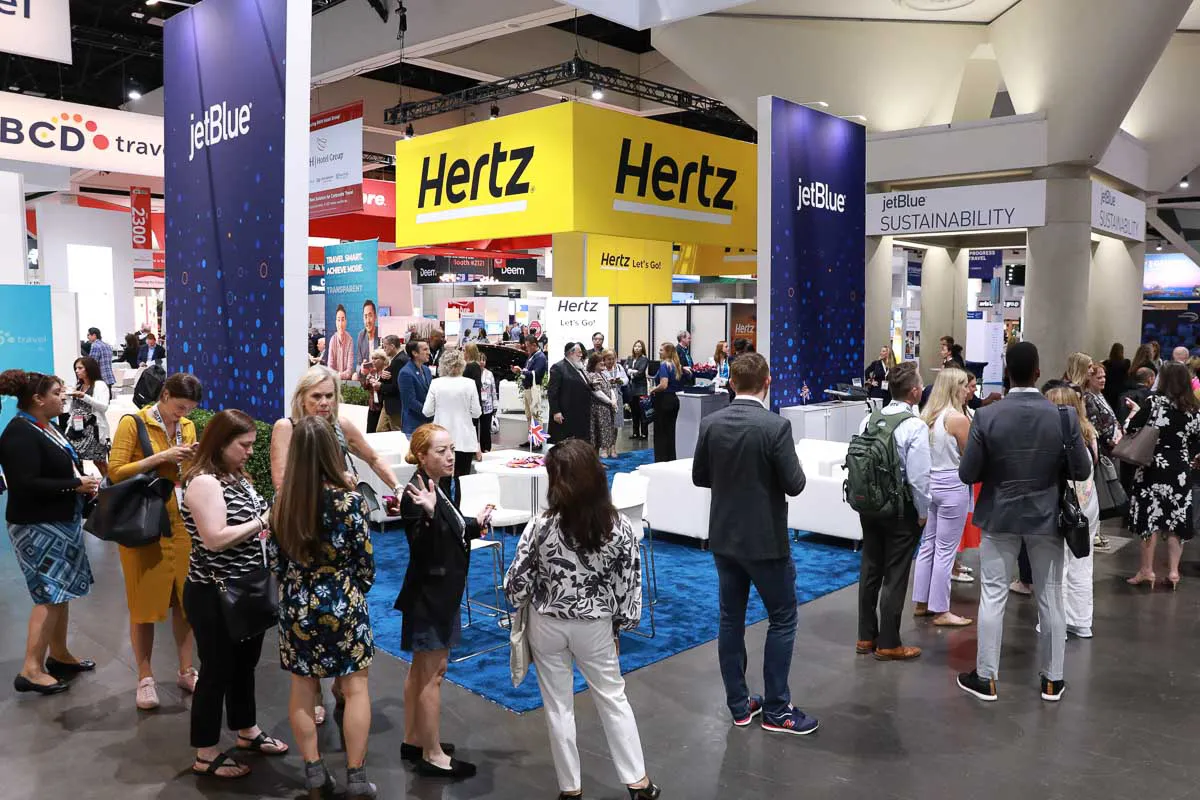 San Diego expo tradeshow photography showcasing busy attendees gathered near custom Hertz and JetBlue convention booths.