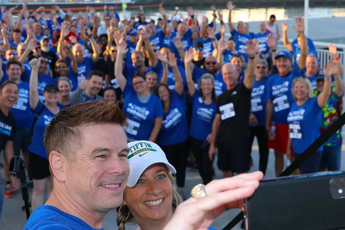 San Diego corporate event photography capturing an energetic group selfie before a conference fun run at Hilton Bayfront.