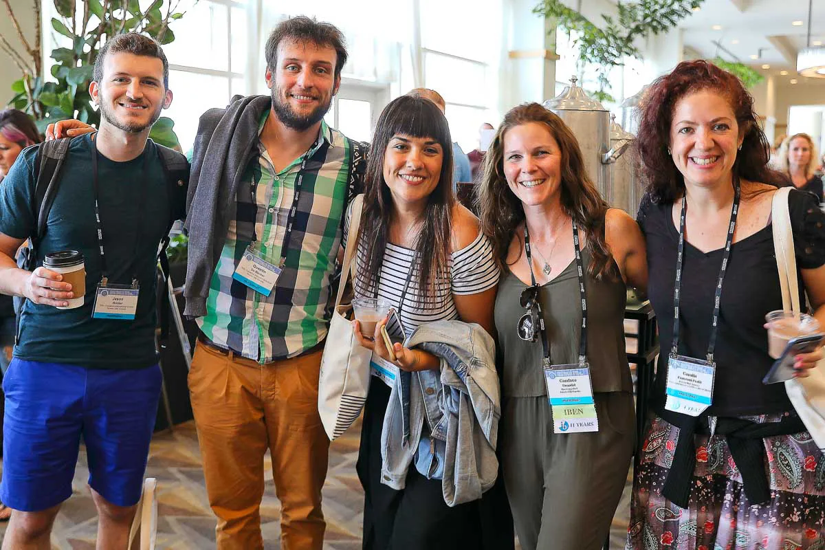 Hilton San Diego Bayfront corporate conference photography capturing a candid group of smiling attendees networking.
