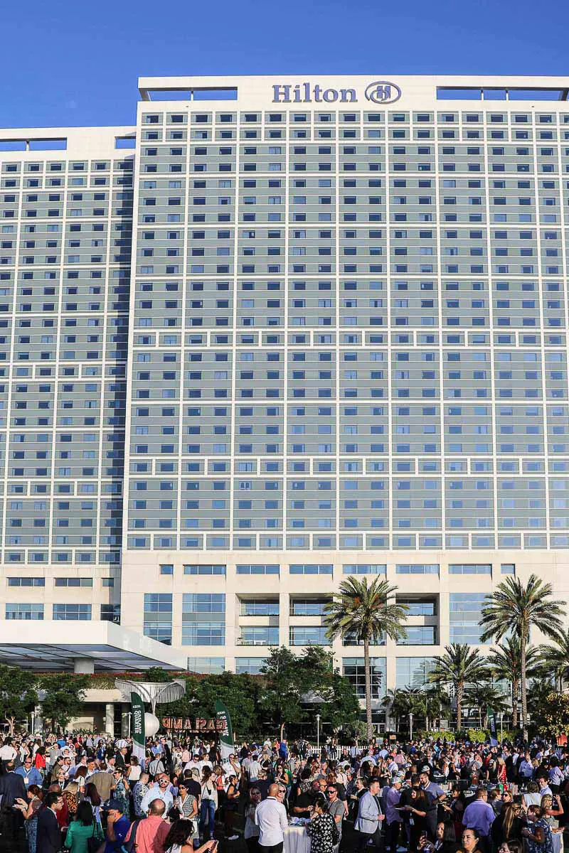 Hilton San Diego Bayfront corporate event photography capturing a large crowd of convention attendees on the plaza below.