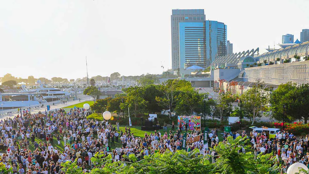 San Diego convention center outdoor event photography capturing a large corporate crowd gathered near the marina at sunset.
